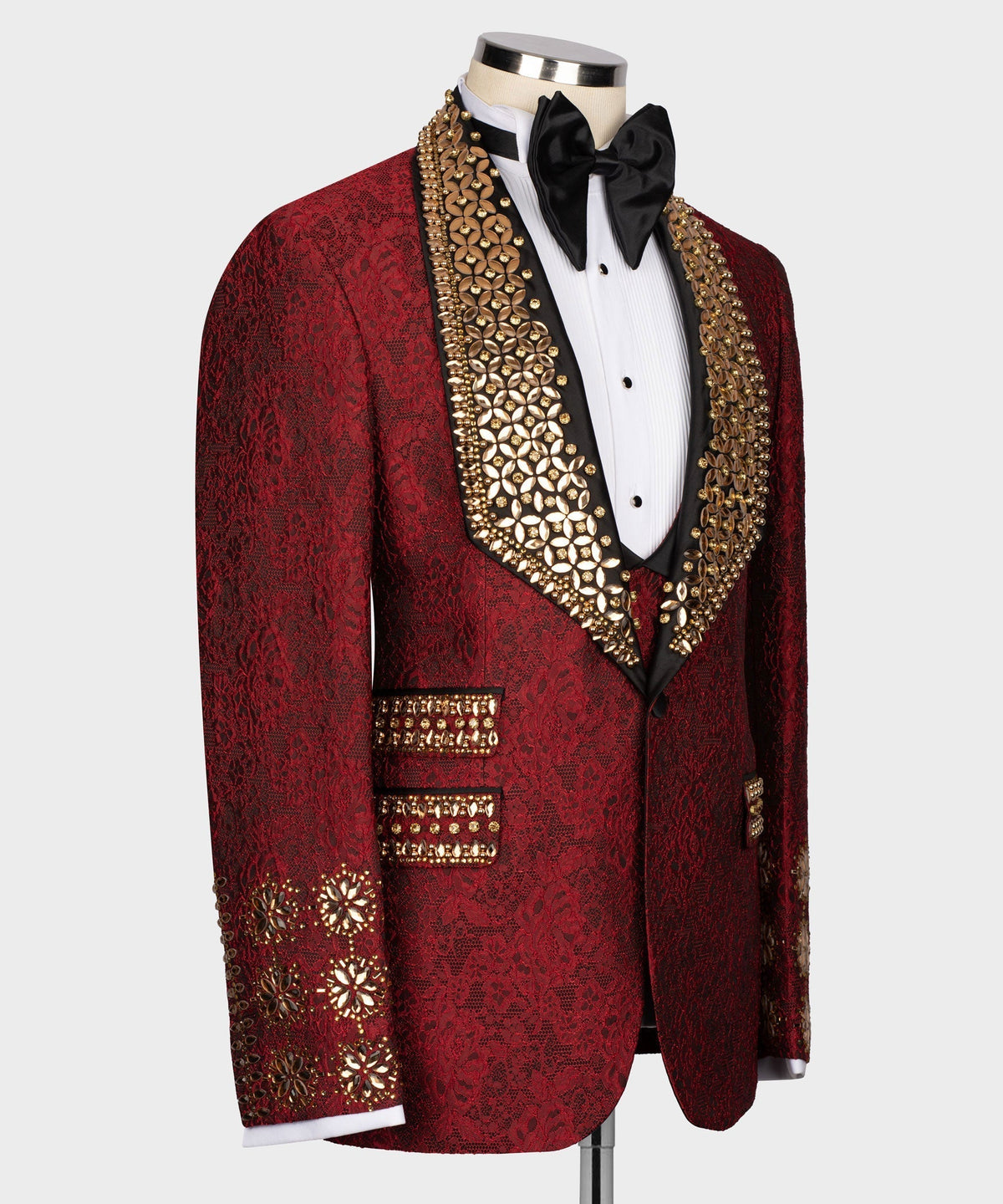 Red tuxedo jacket front view with gold embellished trim over black vest and bow tie