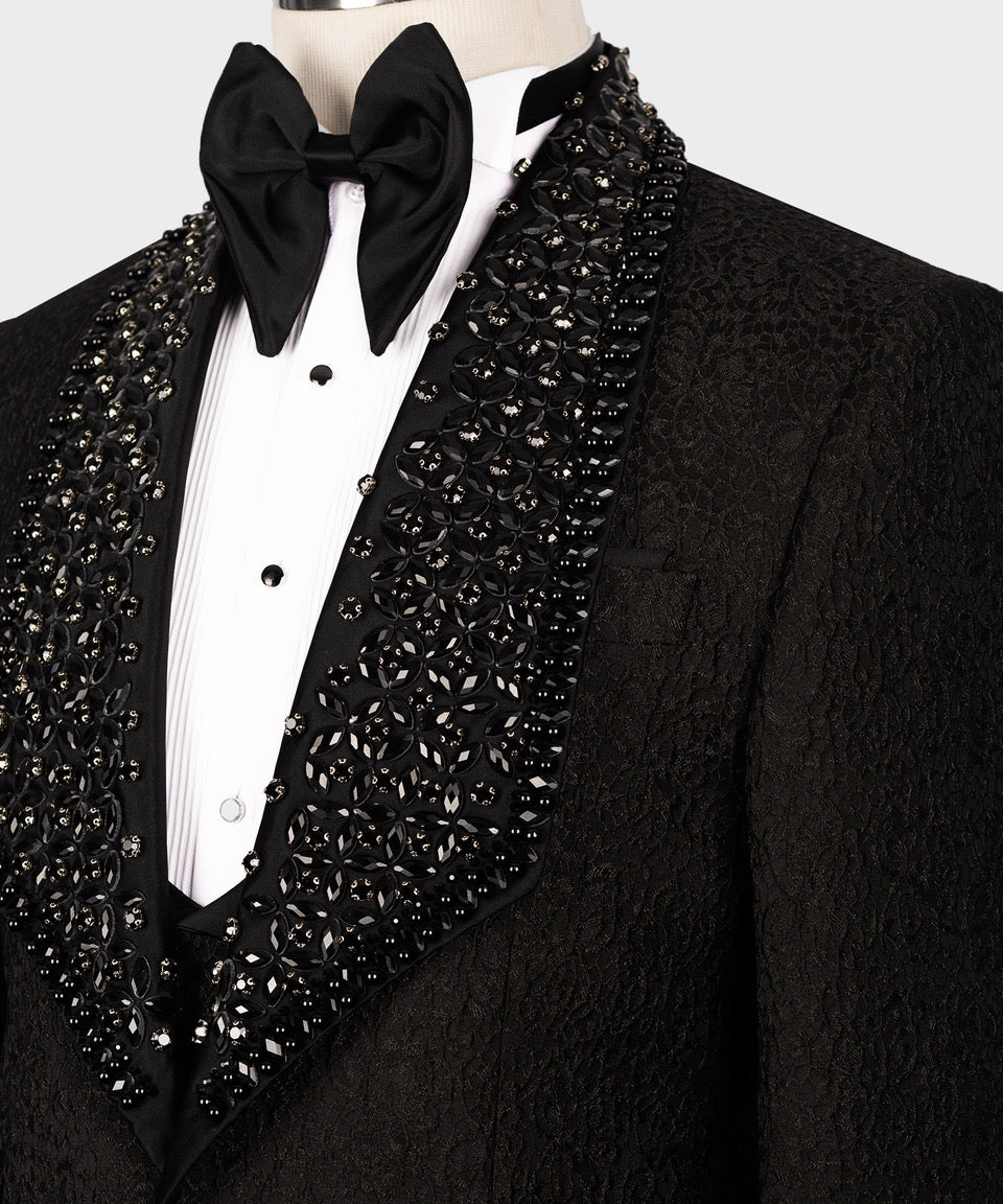 Close-up of black tuxedo lapel with jeweled sequin pattern over satin bow tie