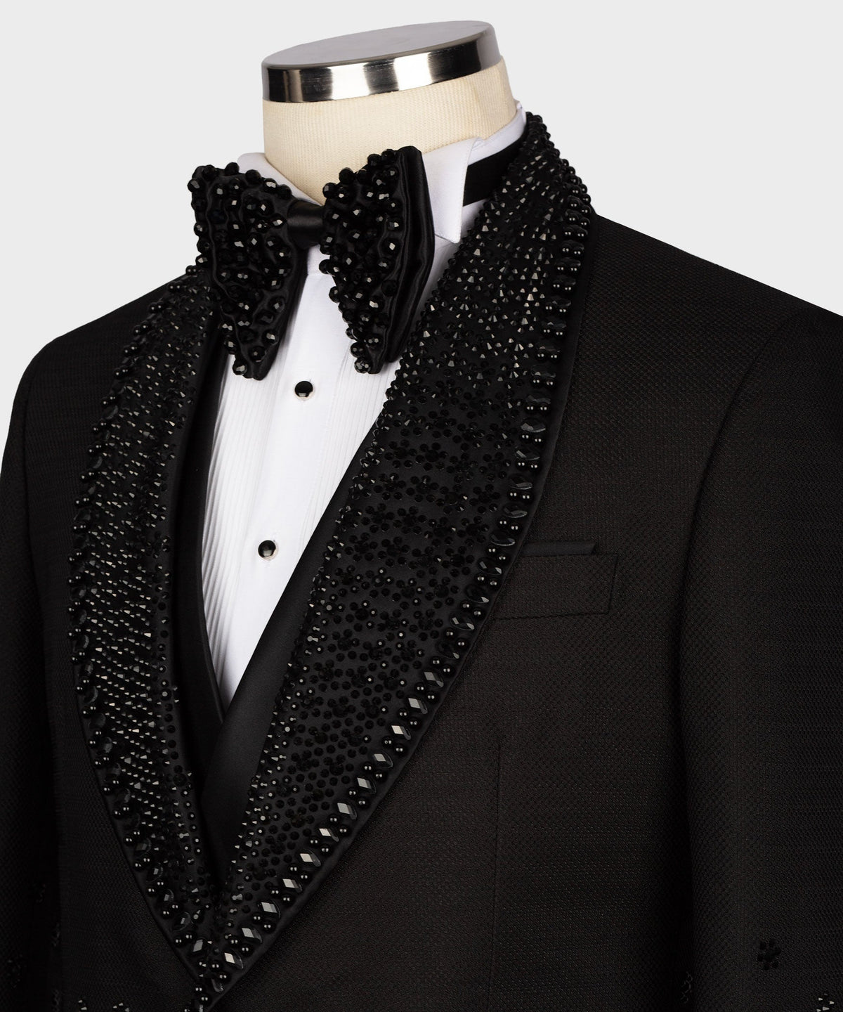 Black tuxedo lapel and bow tie with jeweled sequin trim, matching chest pocket