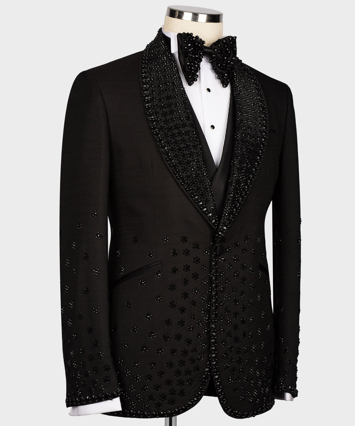 Black tuxedo jacket with sparkly gem trim on lapels and vest, bow tie