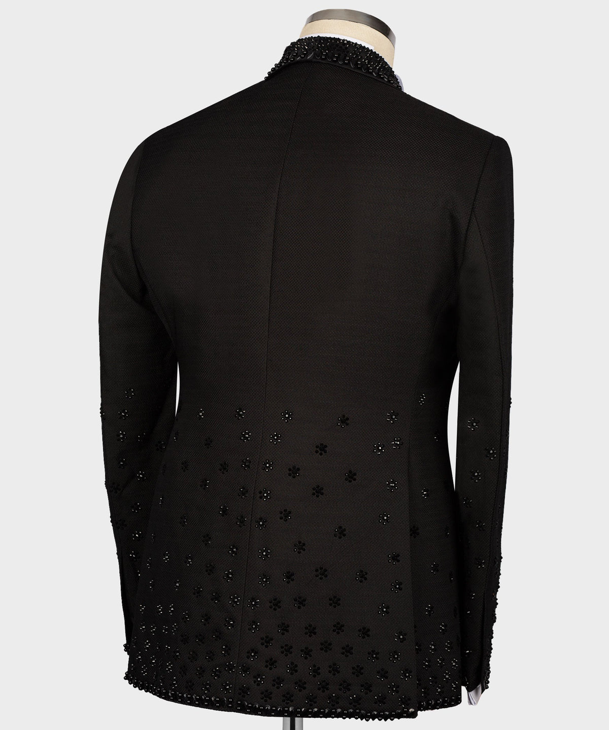 Black tuxedo jacket back with scattered rhinestone pattern and center seam
