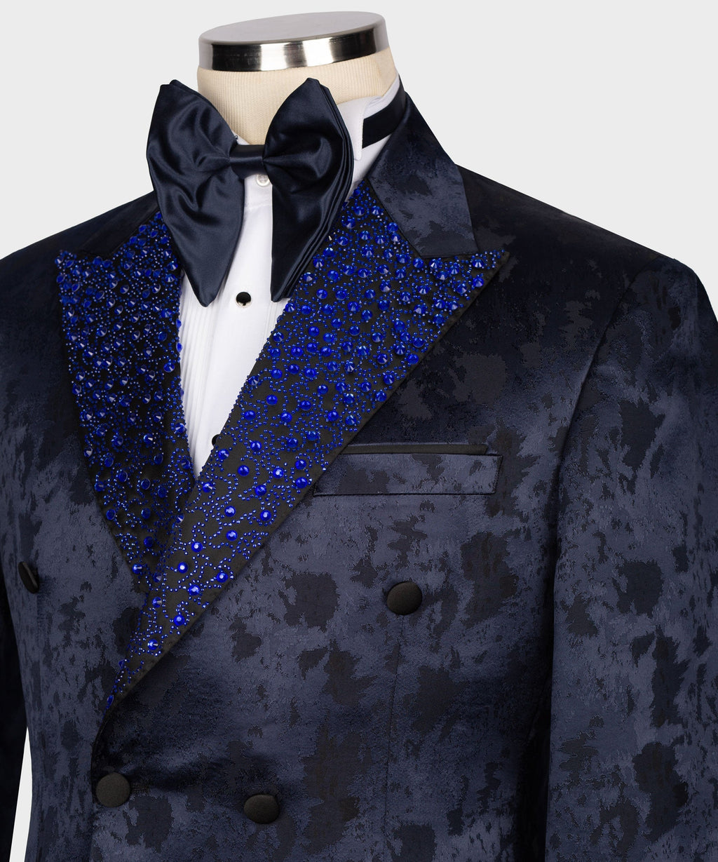 Close-up tuxedo shirtfront with navy bow tie and blue gemstone-embroidered lapels