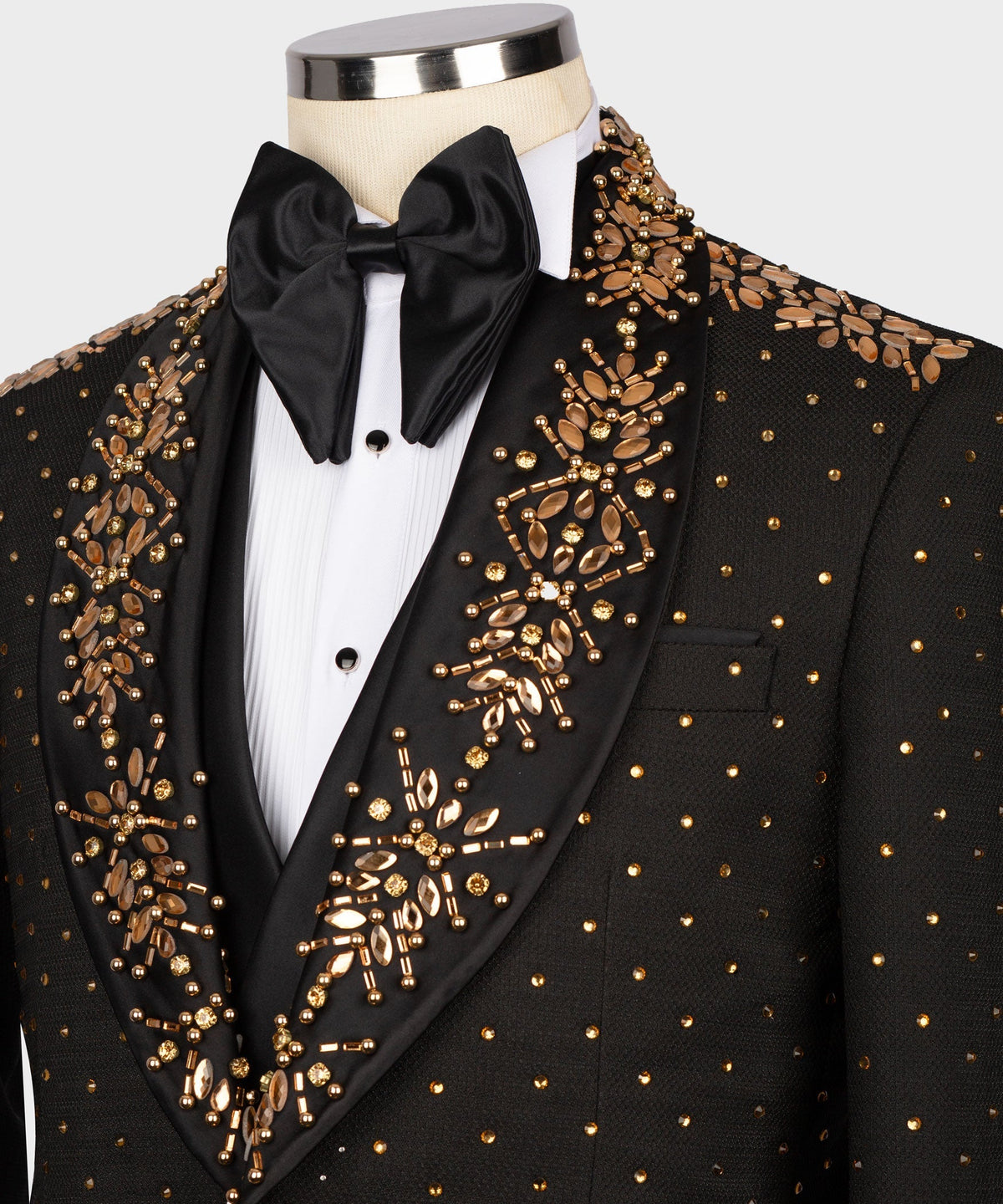Black tuxedo jacket with gold beaded patterns, pocket details, and satin bow tie