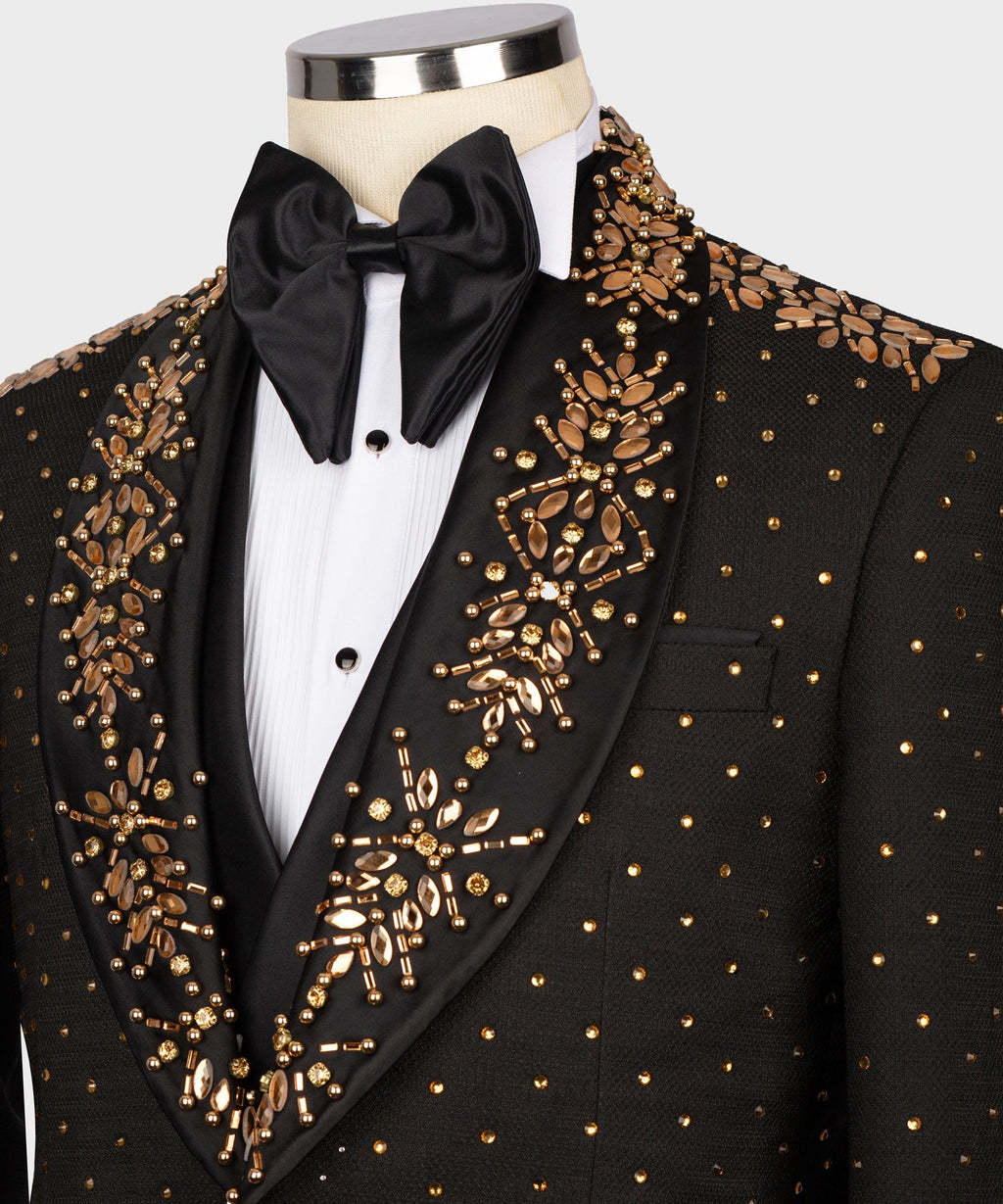 Black tuxedo jacket with gold embroidery, satin bow tie, and pleated white shirt