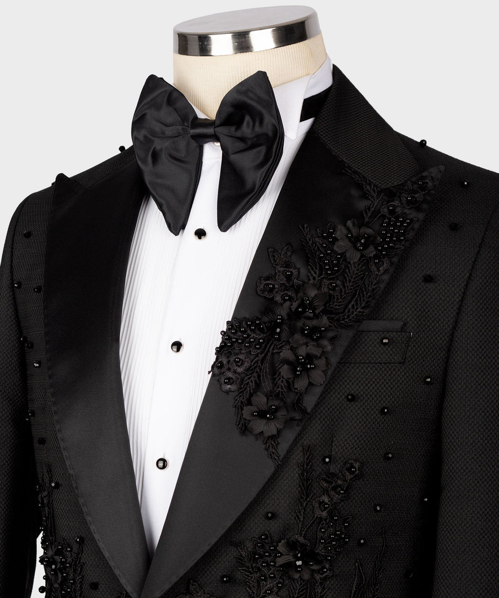 Black tuxedo shirt, bow tie, and floral embellished pocket detail on black vest