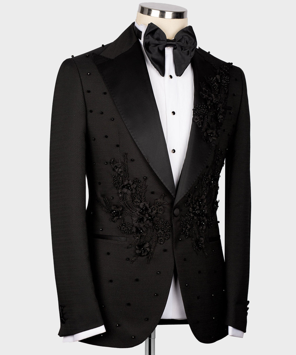 Black tuxedo jacket front view with black bow tie, floral applique panels and vest