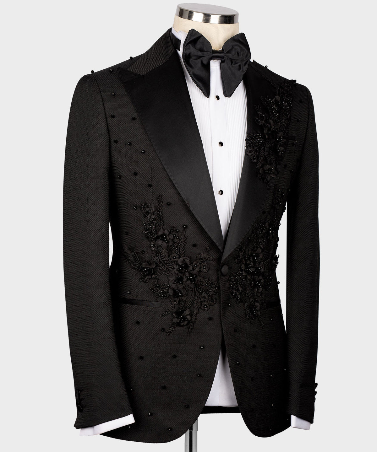 Black tuxedo jacket with floral embroidery across chest and satin-trim lapels