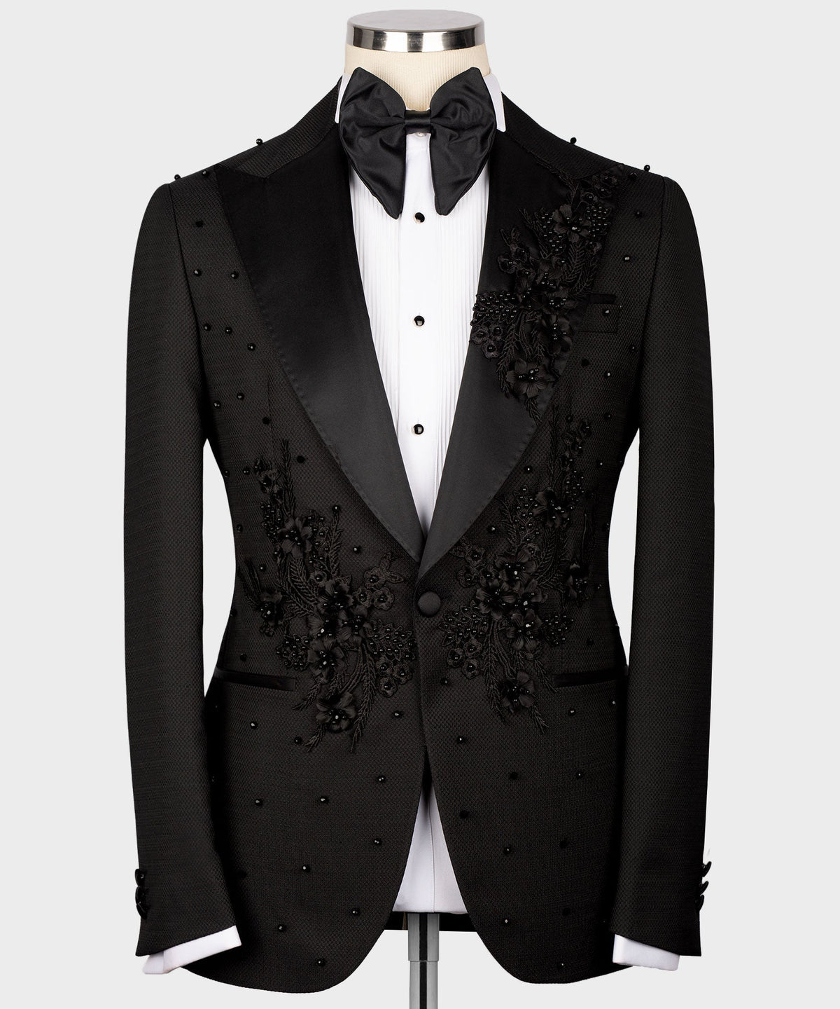 Black tuxedo set: jacket, vest, bow tie, and white dress shirt with floral details