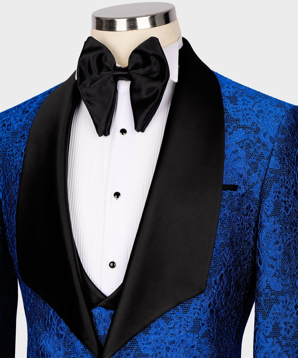 Close-up of black satin bow tie and white shirt placket on blue embossed tuxedo jacket