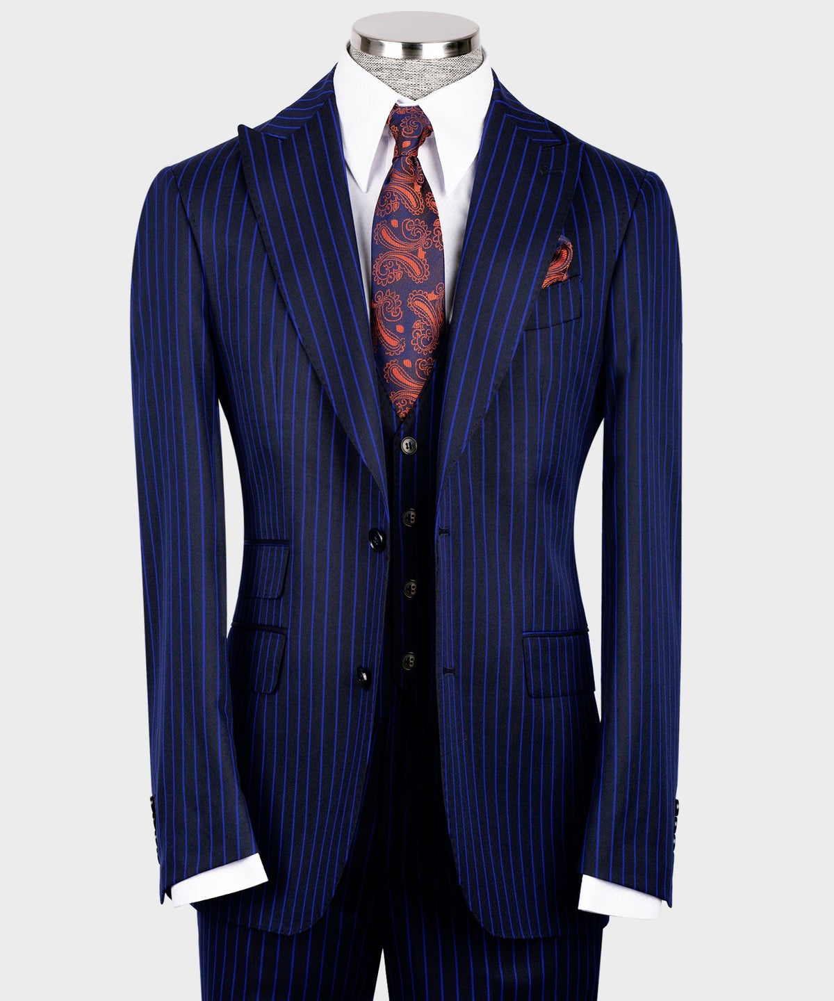 Front view of navy pinstripe suit jacket with flap pockets and dark buttoned waistcoat