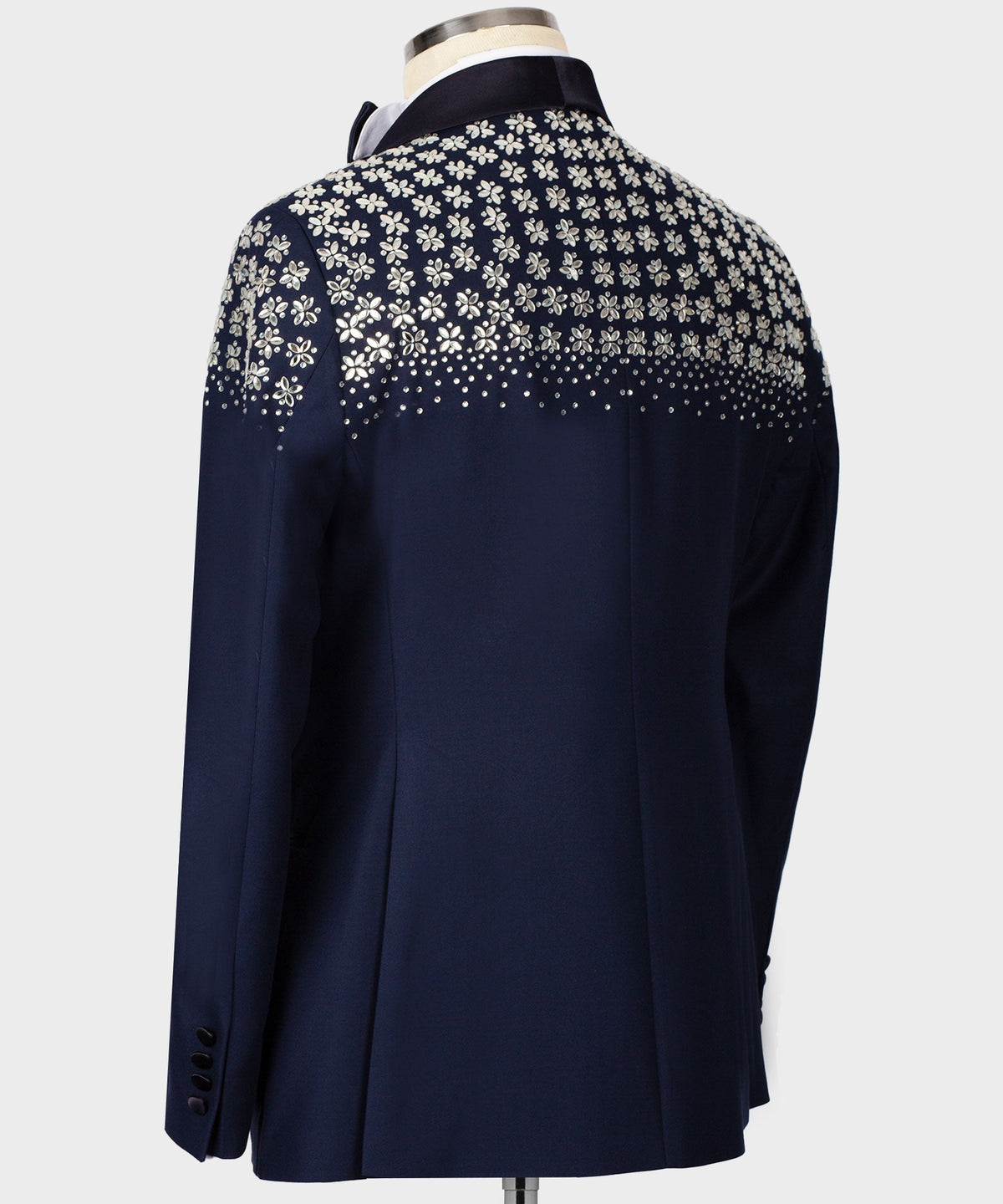 Blue tuxedo back view with floral stone embroidery near shoulders and mid-back