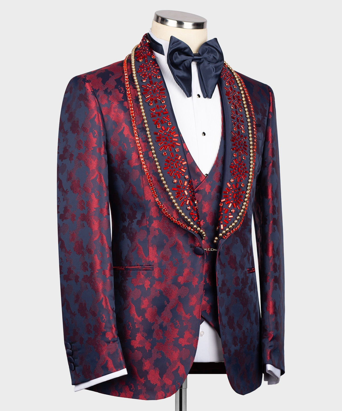Navy tuxedo jacket with red pattern, decorative beaded trim, white shirt & bow tie
