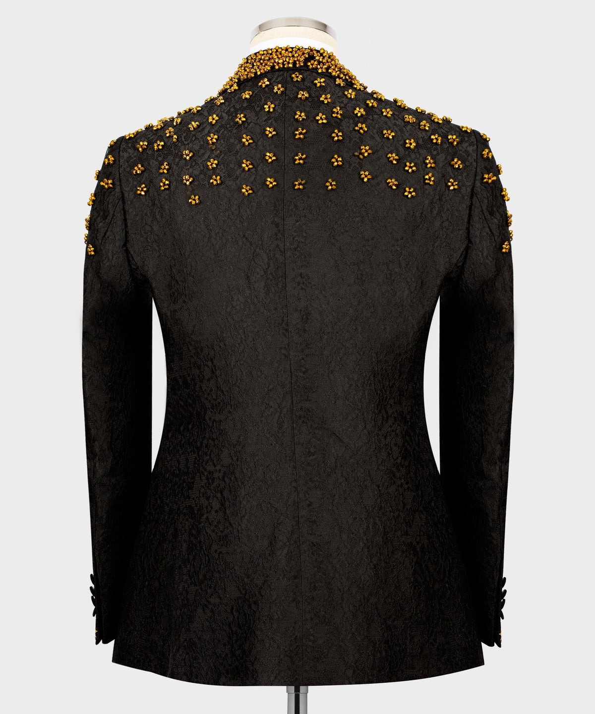 Black tuxedo jacket back view with dense gold bead floral embroidery across shoulders