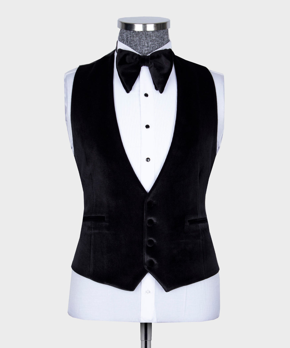 Black velvet tuxedo vest with satin lapels, white shirt, and black bow tie