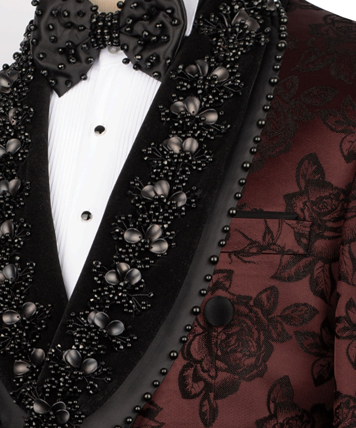 Close-up: black studded lapels with large stones over burgundy floral tuxedo jacket
