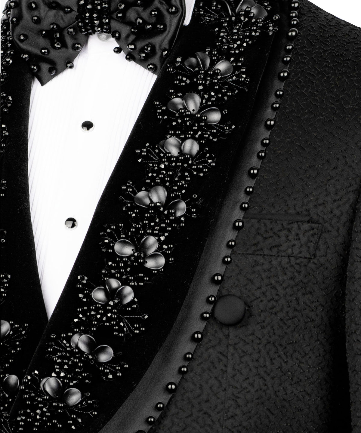 Close-up of stone and bead embroidery on tuxedo lapel with floral clusters