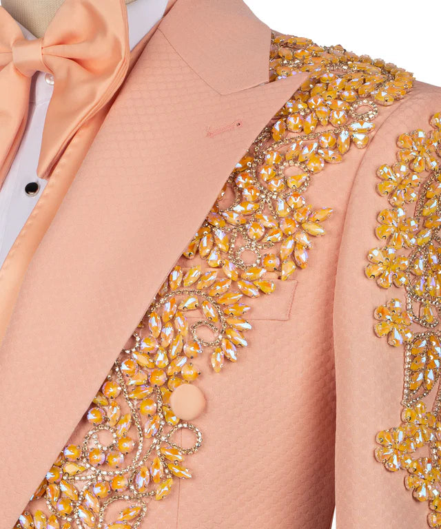 Close-up of a peach blazer with intricate gold embroidery on a white background