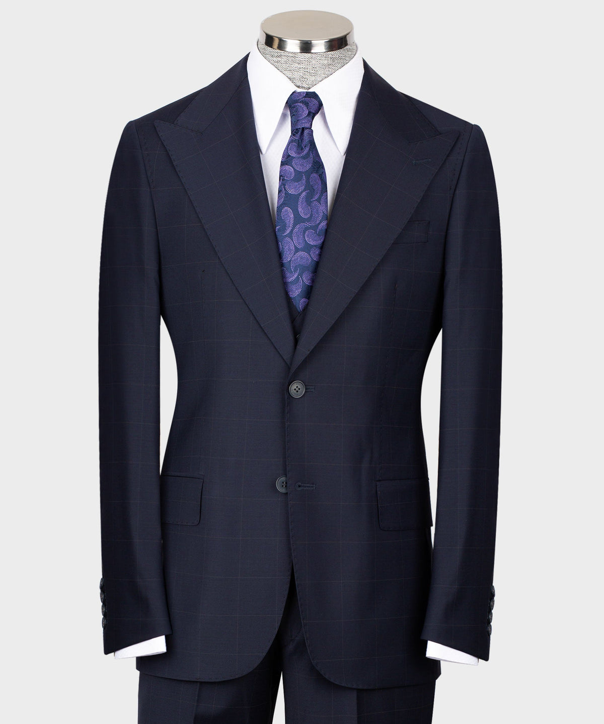 Navy tailored three-piece suit: jacket, vest, white shirt, purple patterned tie