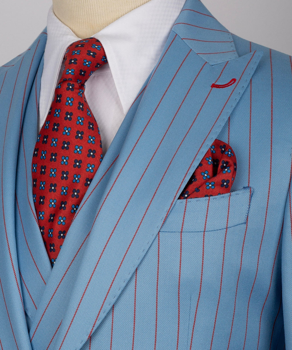 Close-up of light-blue pinstripe suit jacket with red patterned tie and pocket square