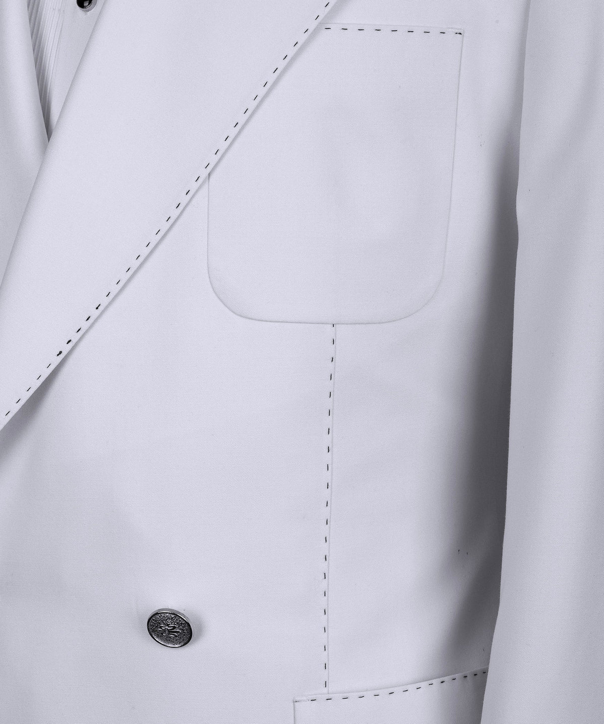 Close-up of white tuxedo jacket front pocket and double-breasted buttons