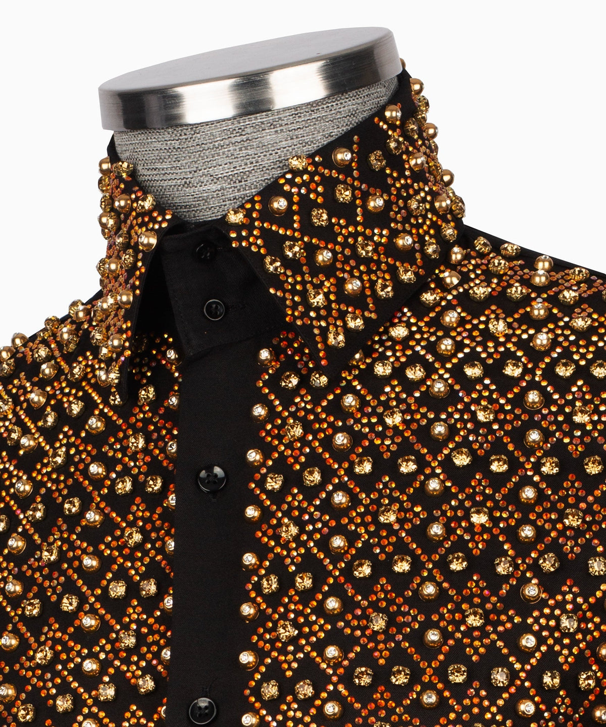 Close-up of black shirt front with dense gold stone embroidery and black buttons