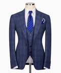 Blue plaid three-piece suit jacket with notched lapels, vest, patterned tie, and pocket square