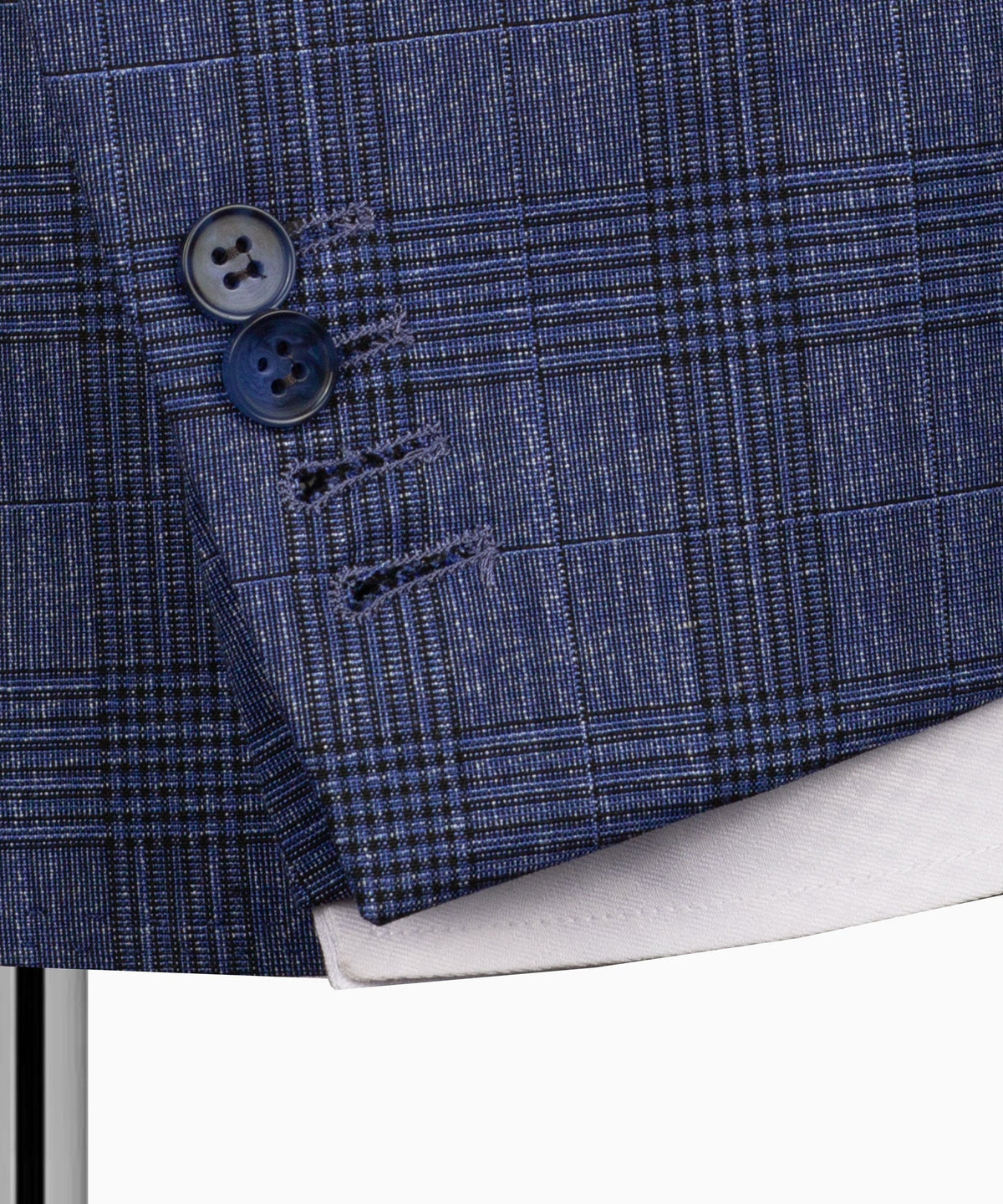 Close-up of blue plaid suit jacket cuff with two dark buttons