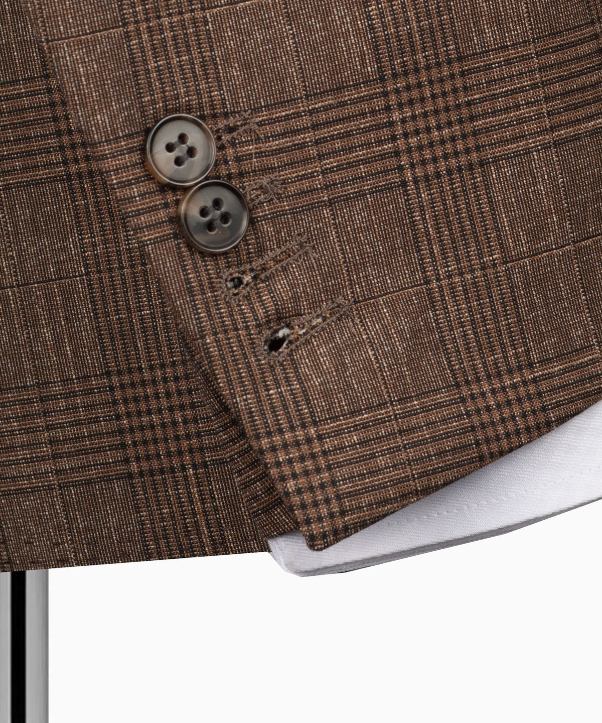 Detail close-up: brown plaid jacket cuffs and buttons