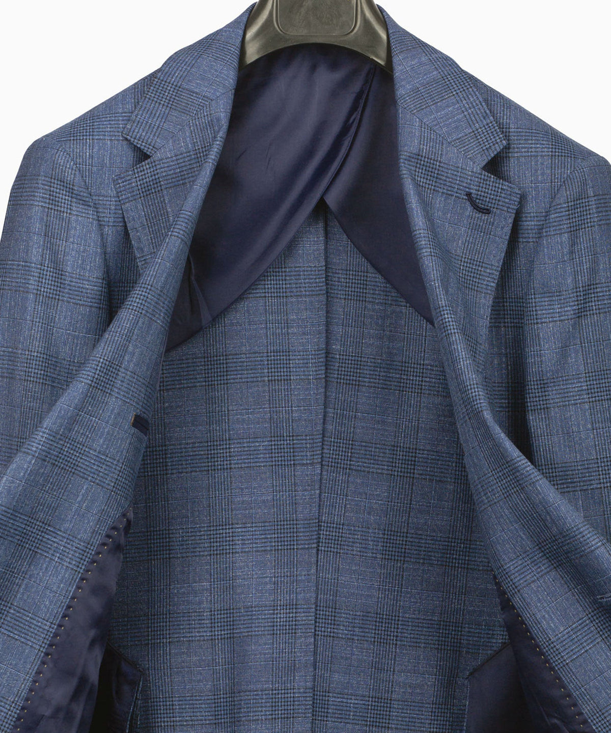 Blue plaid suit jacket interior with wide lapels and tailored seam panels