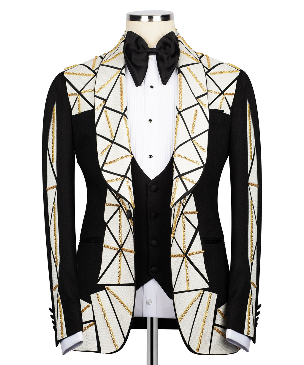 Patchwork tuxedo jacket with black bow, white patterned lapels, gold chain embroidery