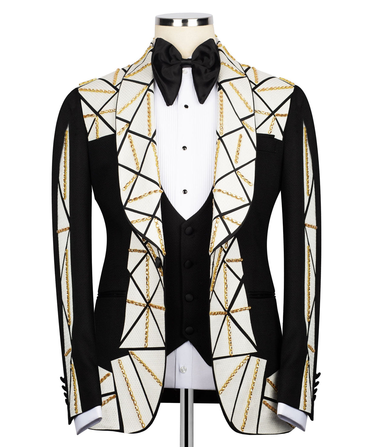 Patchwork tuxedo suit: black jacket, white geometric panels, gold chain embroidery, bow tie