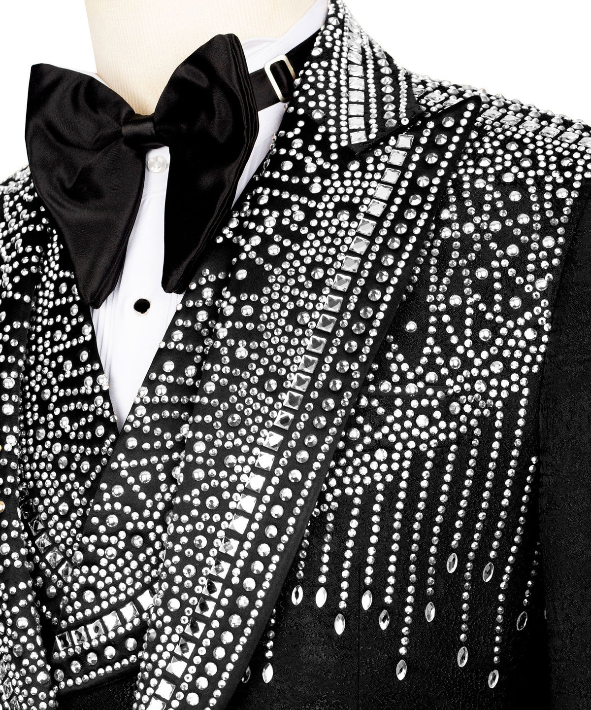 Close-up: black tuxedo bow tie and stone-embossed lapel with patterned trim