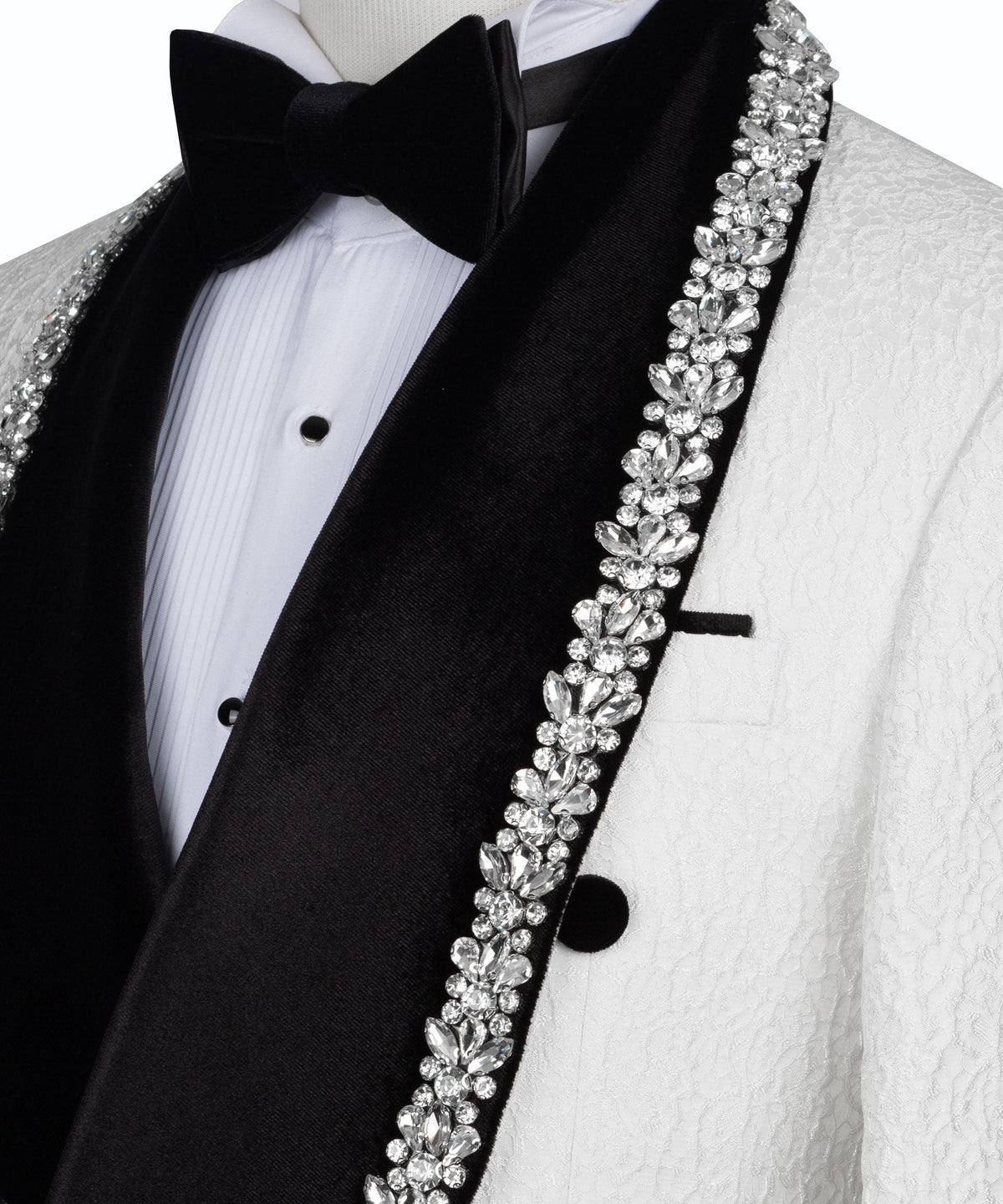 Close-up of rhinestone-embroidered lapel trim on black satin facing, with bow tie