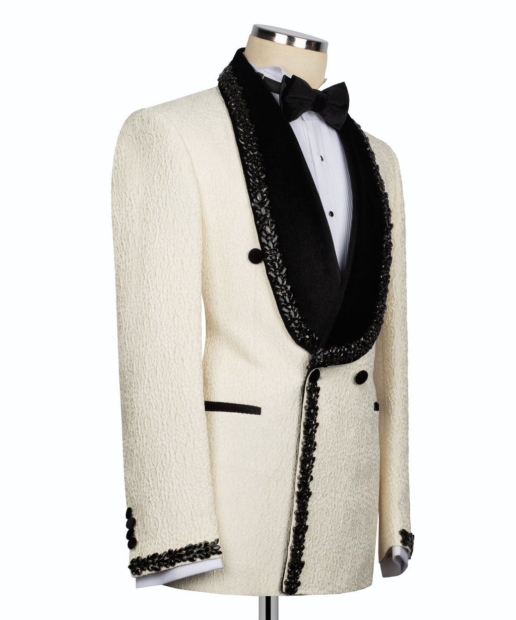 Off-white tuxedo jacket with black lapels, bow tie, and stone-embroidered front trim