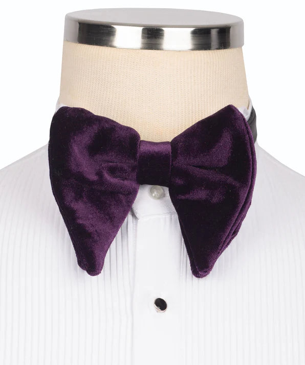 Koss Atelier deep purple velvet bow tie with a pointed, oversized butterfly silhouette on a white dress shirt.