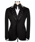 Black tuxedo suit with jeweled collar, satin bow tie, and buttoned vest