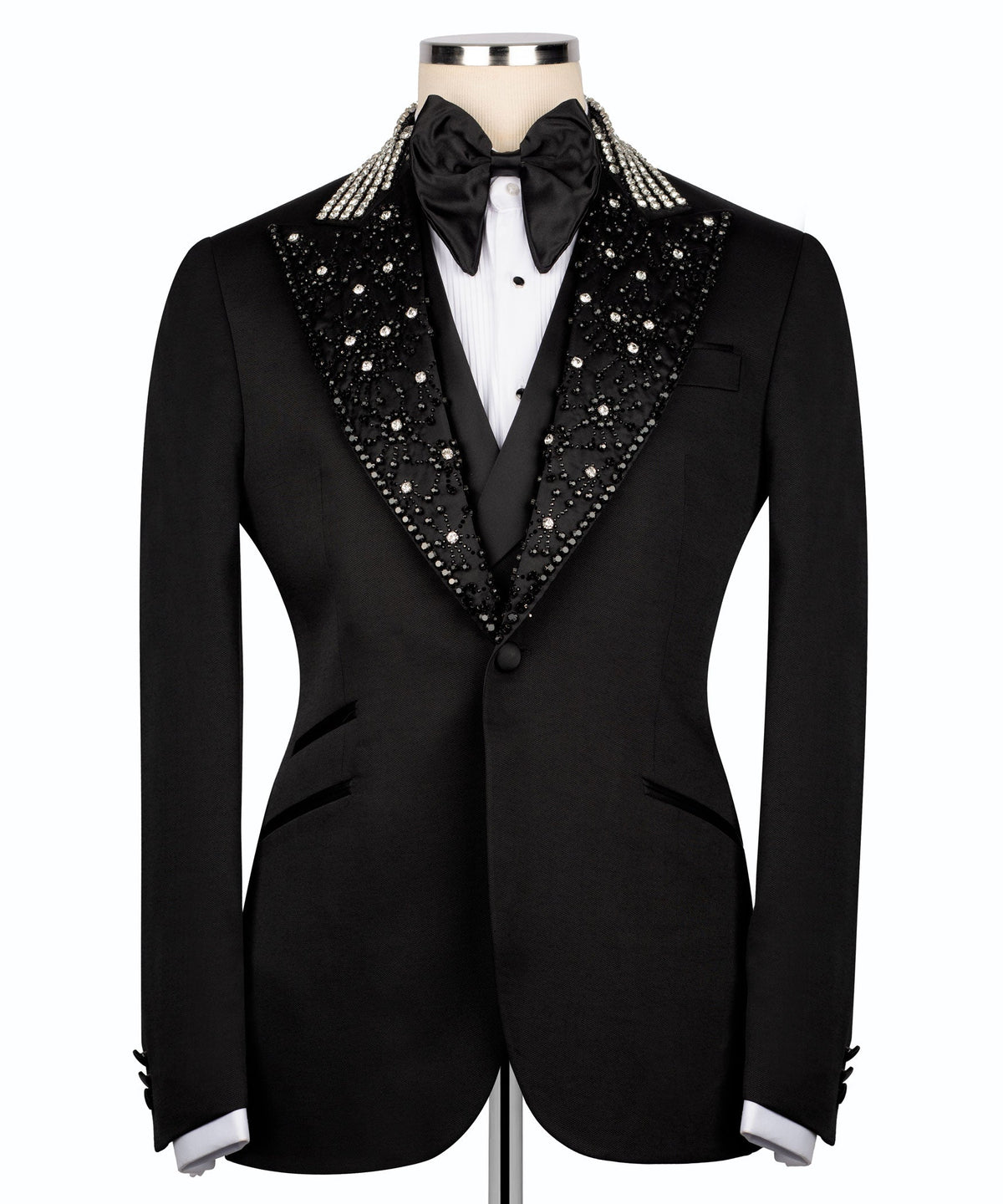 Black tuxedo suit with jeweled collar, satin bow tie, and buttoned vest