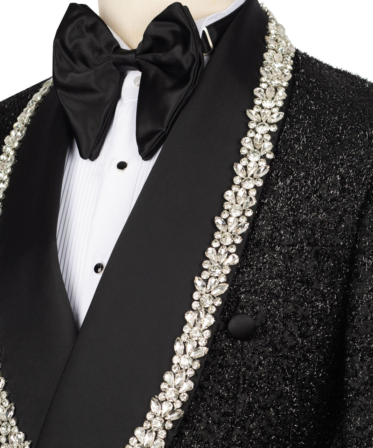 Close-up: black tuxedo bow tie and white-stone embroidered lapel with cluster gems
