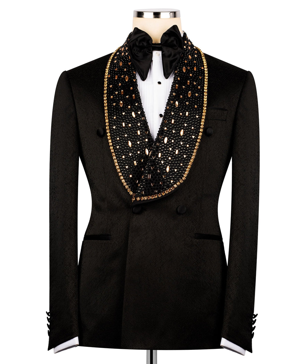 Black double-breasted tuxedo with gold embroidered lapels, bow tie, and structured waist