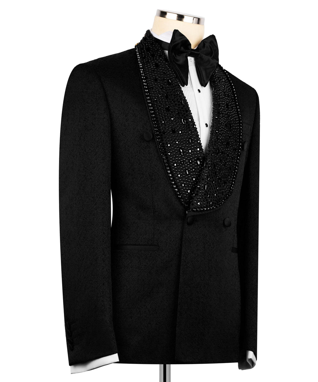 Black tuxedo jacket with long lapels, stone embroidery, and black bow tie