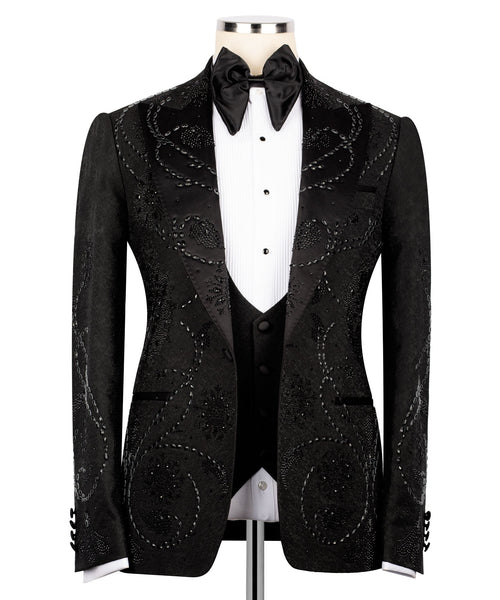Black embellished tuxedo jacket with satin lapels, bow tie, and front button closure