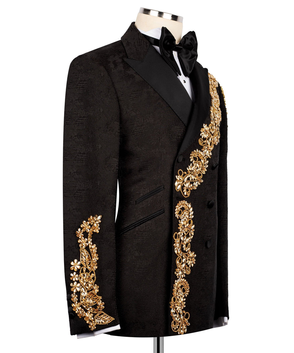 Black tuxedo jacket with gold embroidered cuffs and diagonal accent panel, black bow tie