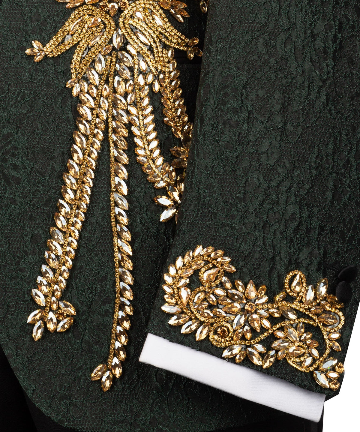 Close-up of green jacket cuff with white lining and gold embroidered scroll design