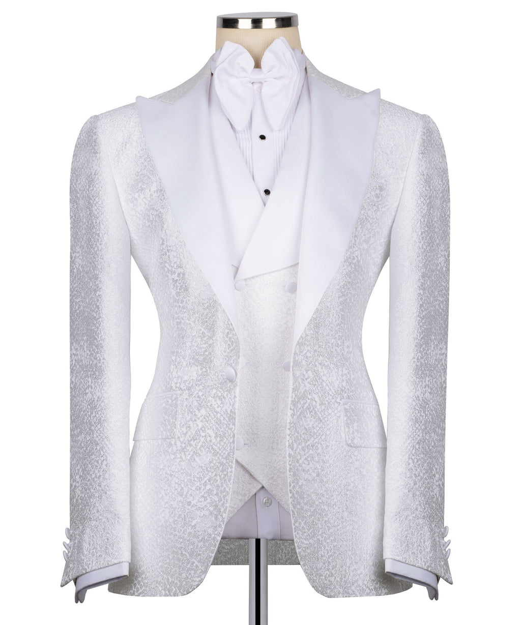 White tuxedo jacket with stone-embroidered lapels, bow tie, and matching vest