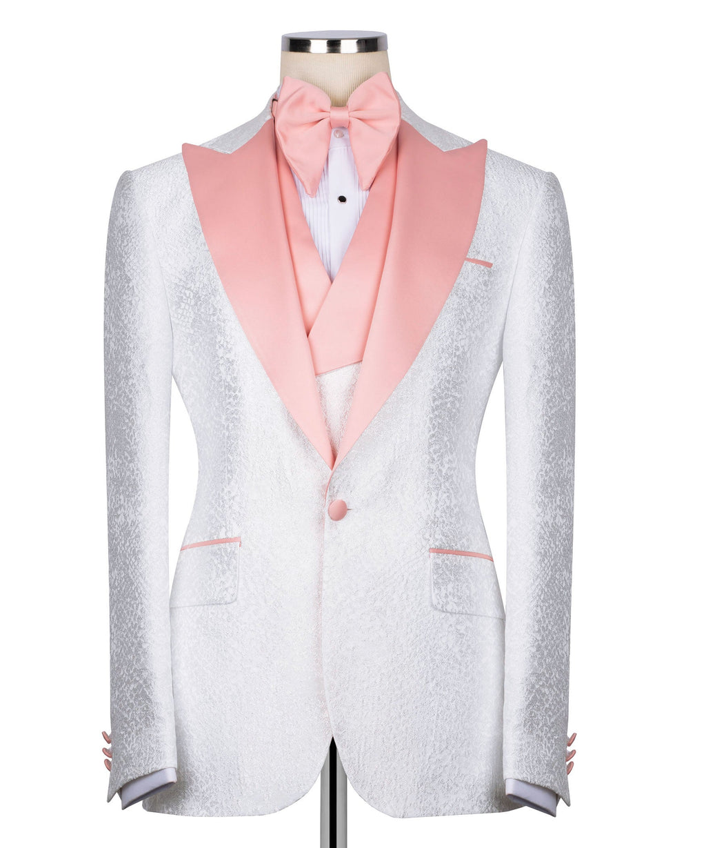 White stone-embroidered tuxedo jacket with pink vest insert and pink bow at collar