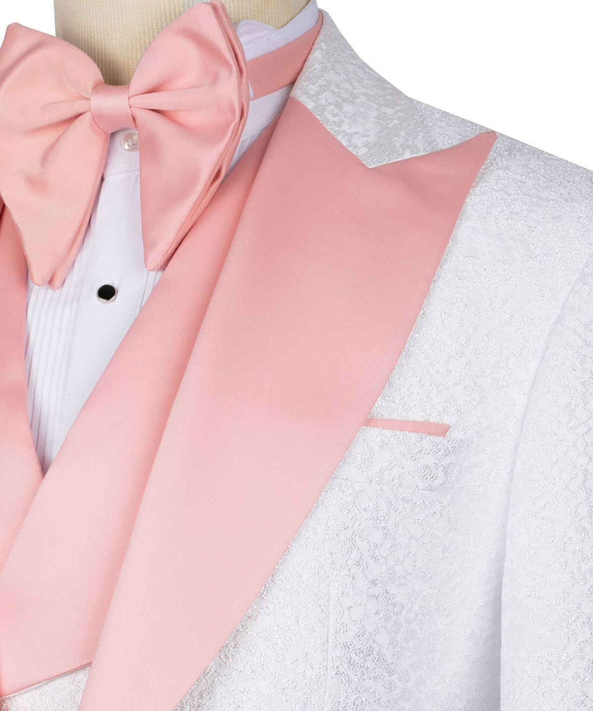 Close-up of pale pink satin lapel and bow on white tuxedo jacket