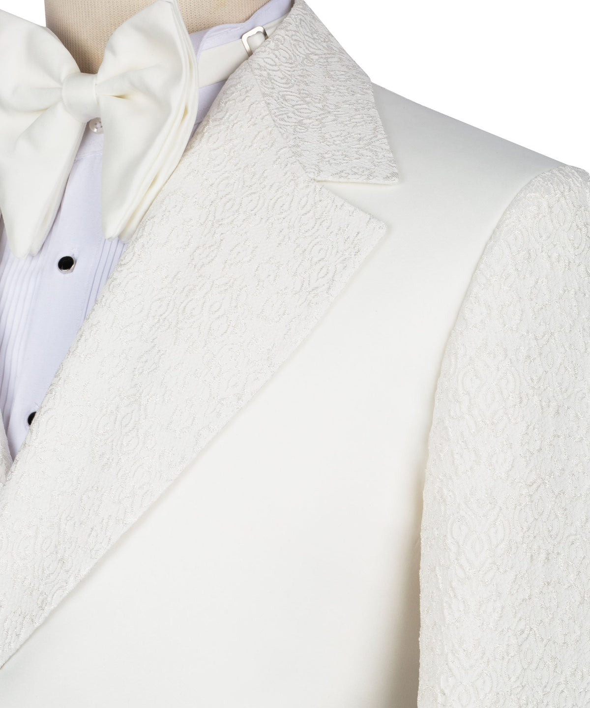 Close-up of cream tuxedo lapel and bow tie over light dress shirt