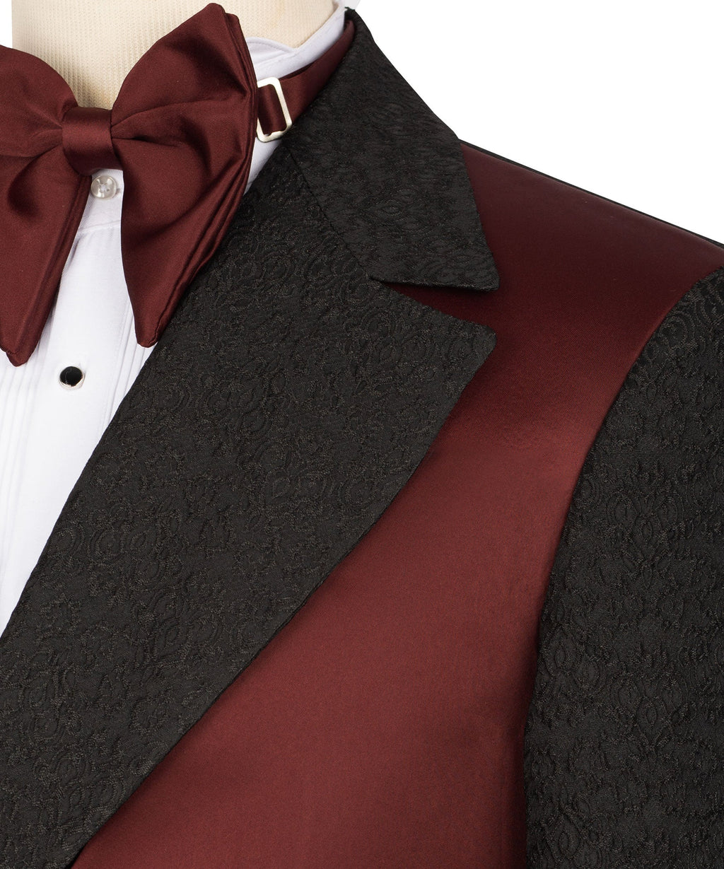 Burgundy bow tie with white shirt, black patterned lapel, maroon vest panel