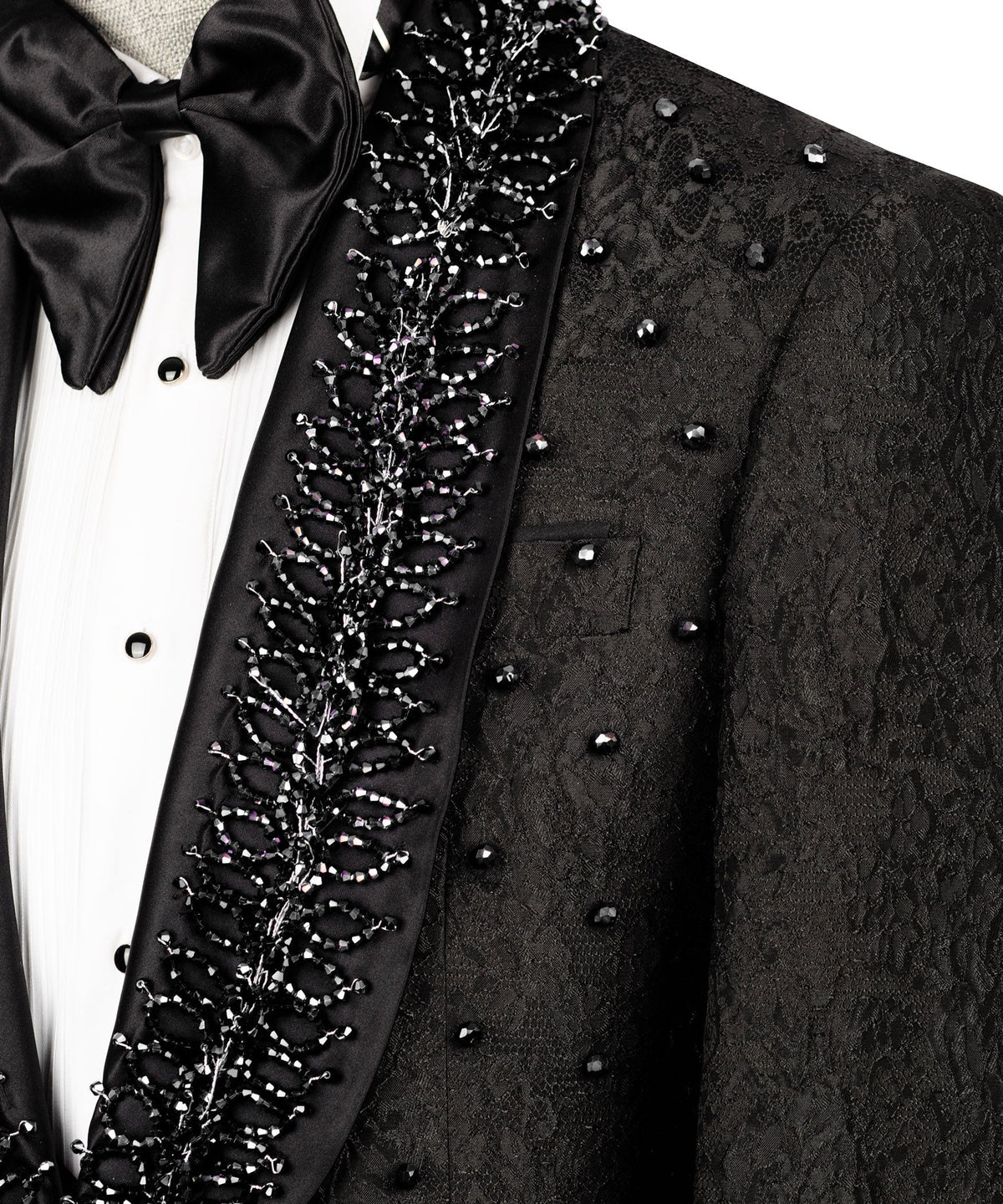 Close-up: black tuxedo lapel embroidery with bow tie and white shirt front