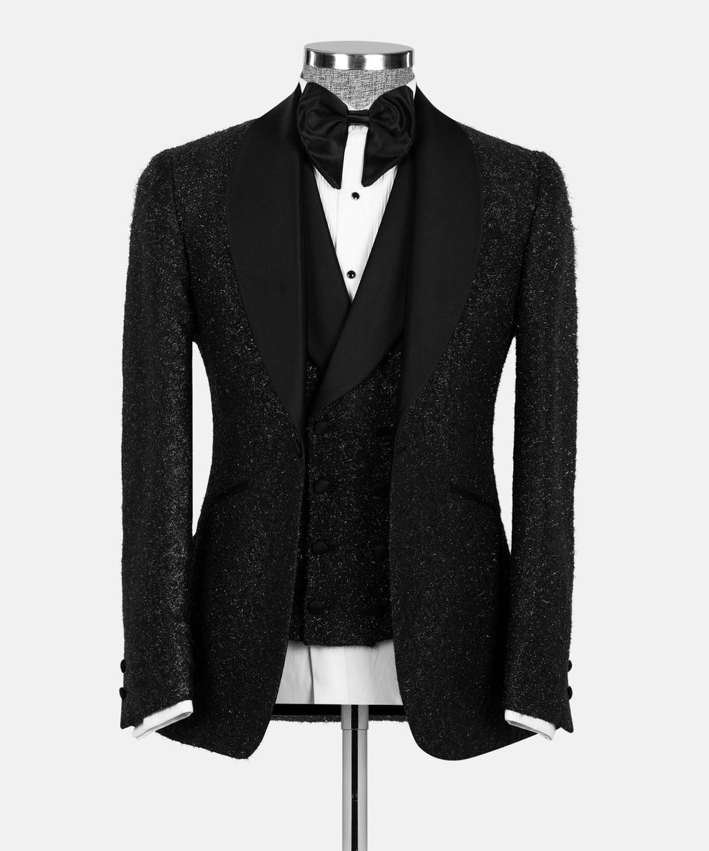 Black glitter tuxedo jacket with satin lapels, bow tie, and vest set on mannequin